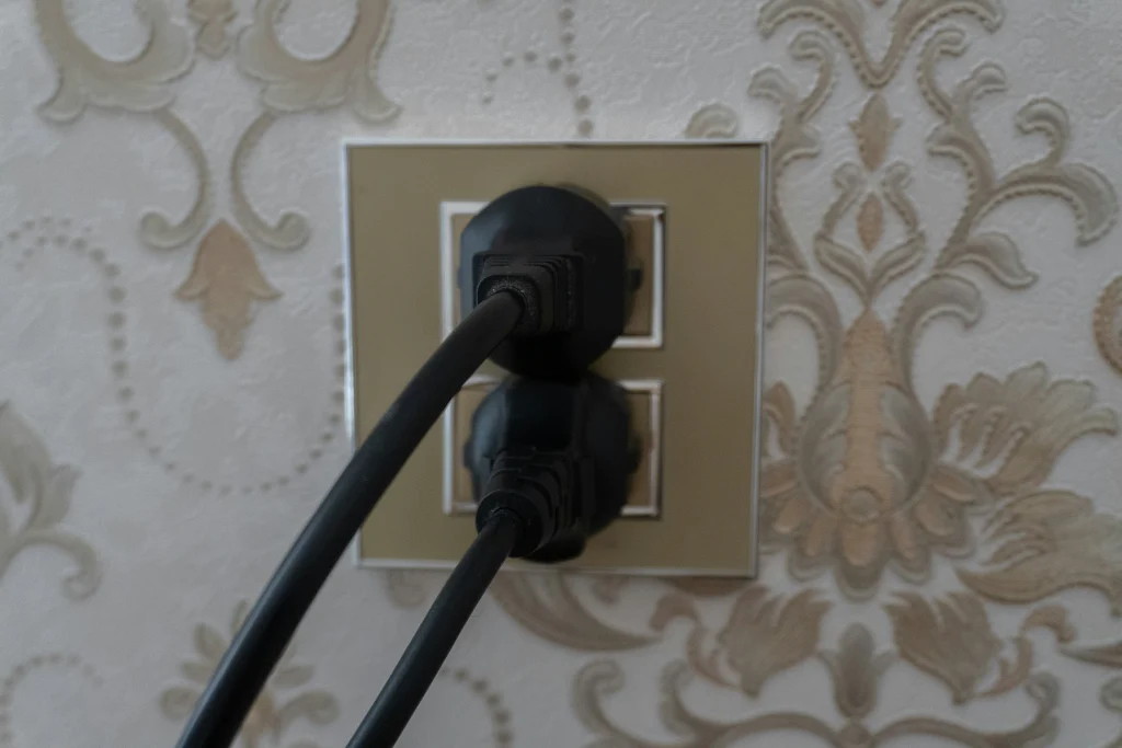 Standard U S wall outlet with two plugs connected